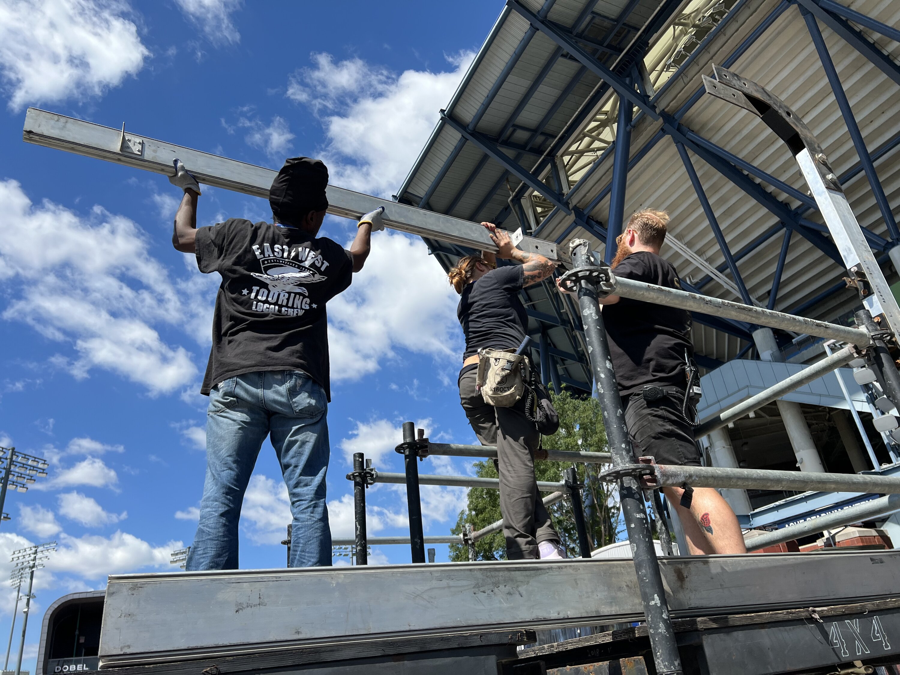 Union crew hands-on with outdoor staging structure