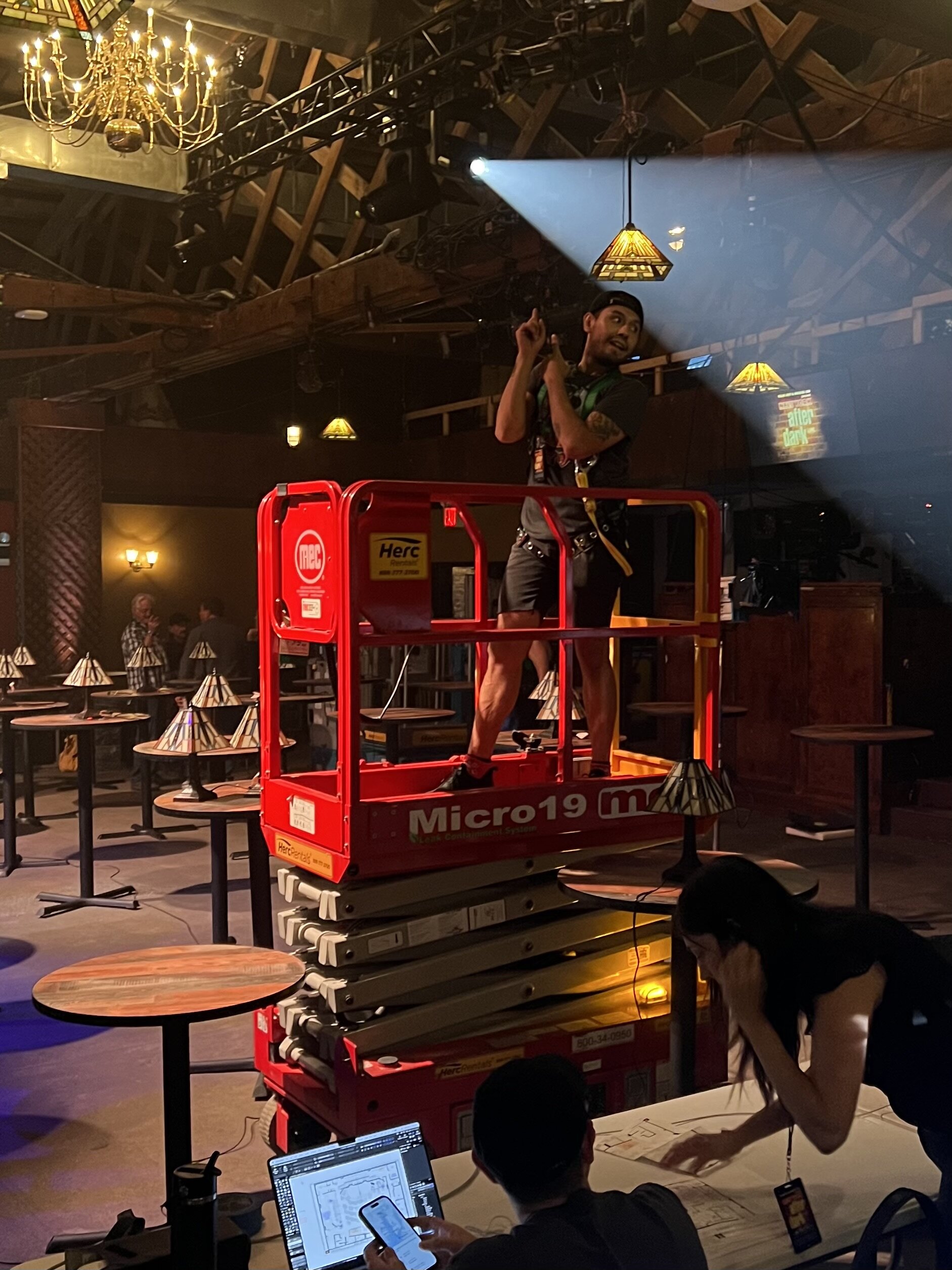 Sean Saphire on a scissor lift at a venue event