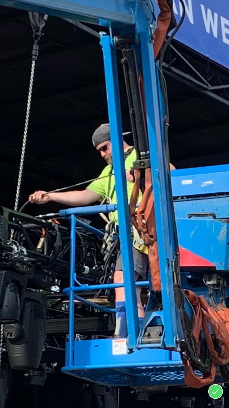 Sean Saphire operating a lift during the US Open Fan Week load-in